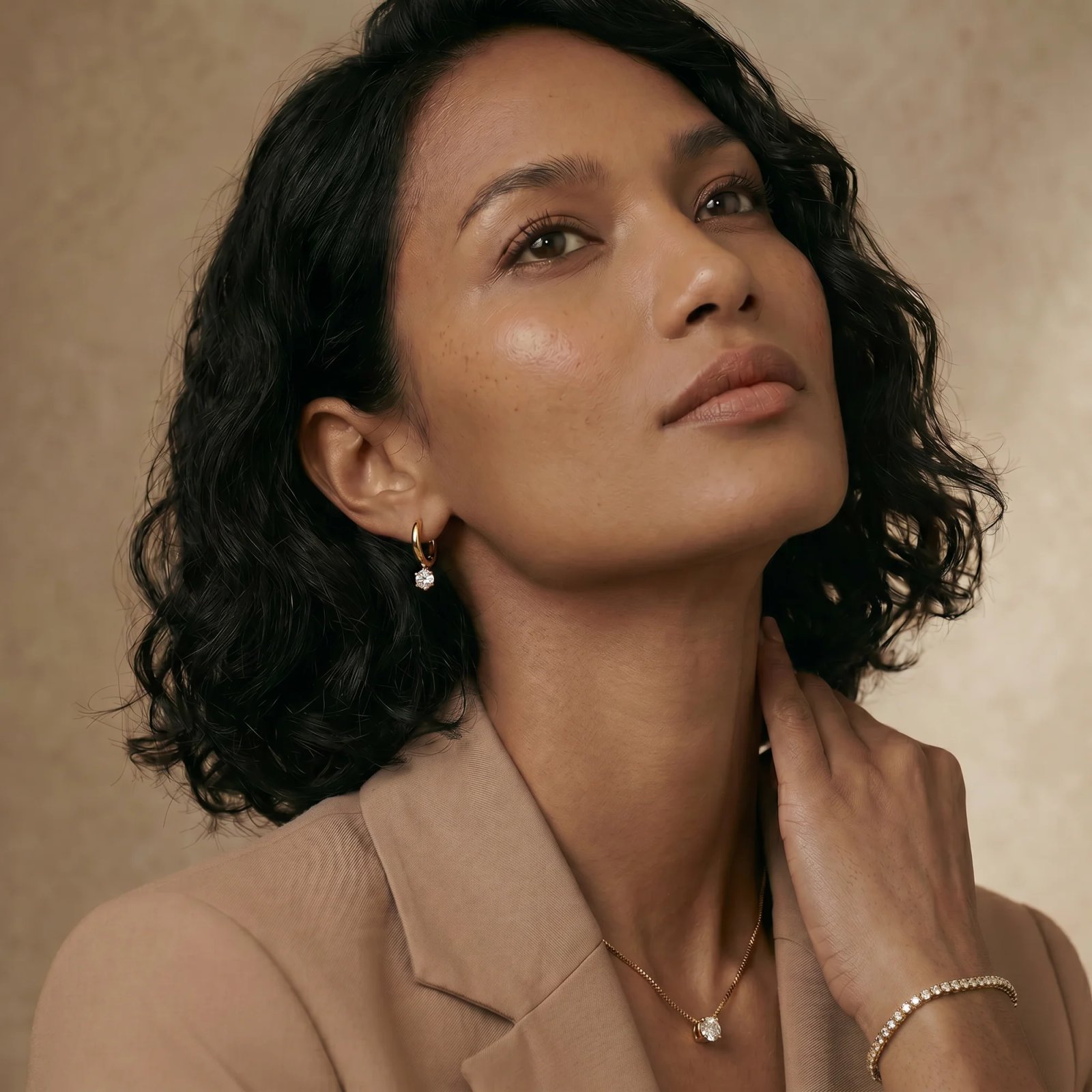 Model wearing 9KT gold lab-grown diamond solitaire pendant and hoops